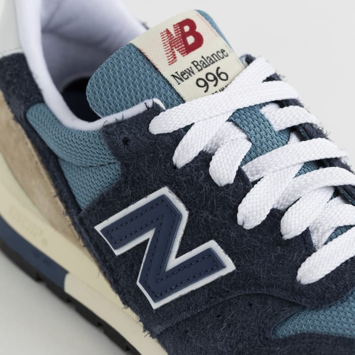 Detailed look at a blue and white New Balance shoe.